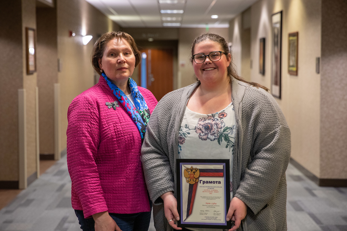Dr. Ivliyeva (left) presents Narrie Loftus (right) with the 2022 American Council of Teachers of Russian (ACTR) annual Post-Secondary Russian Scholar Laureate Award for her passion and commitment to Russian language and literature.